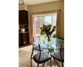 A dining room with a glass table and chairs.