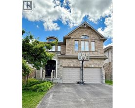 A house with a basketball hoop in front.