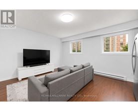 A living room with a grey couch and a flat screen TV.