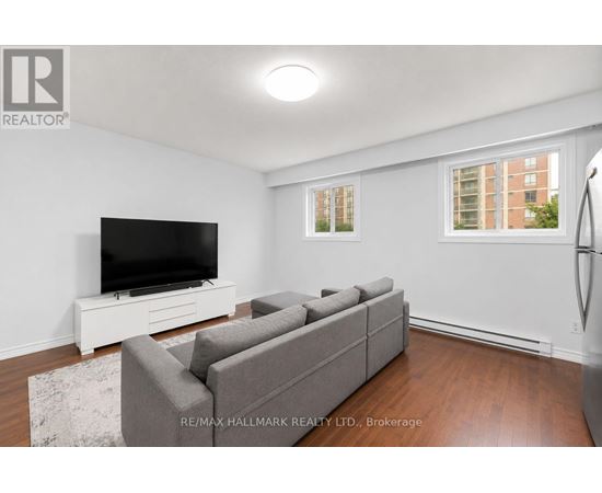 A living room with a grey couch and a flat screen TV.
