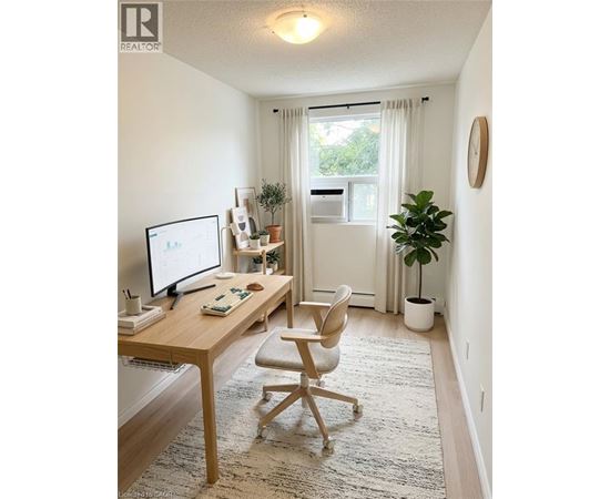 A home office with a desk, chair, and computer.