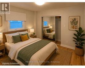 A bedroom with a bed, nightstands, and a plant.
