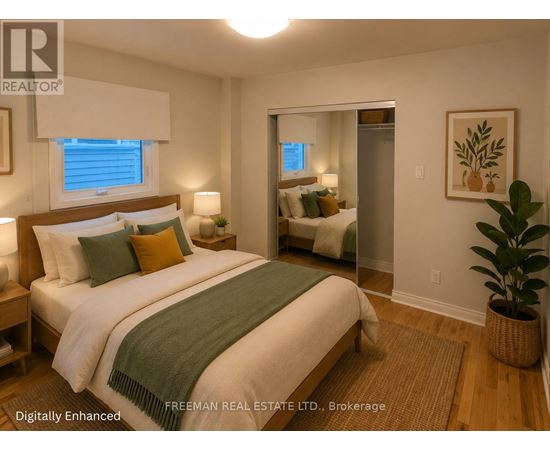 A bedroom with a bed, nightstands, and a plant.