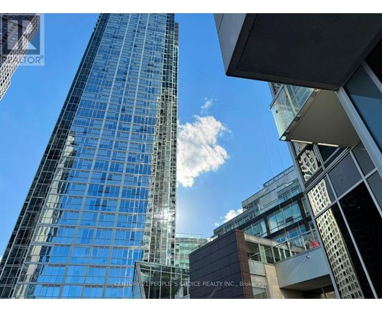 A tall glass building with the name CENTURY 21 PEOPLE'S CHOICE REALTY INC. on the side.