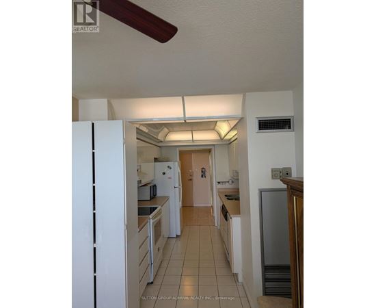 A kitchen with white appliances and a white refrigerator.