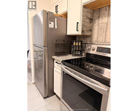 A kitchen with a stainless steel refrigerator and a stainless steel oven.