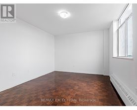 Empty room with wooden floor and white walls.