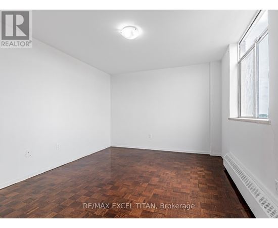 Empty room with wooden floor and white walls.