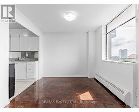 A spacious, empty room with a window overlooking a cityscape.