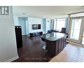 A kitchen with a black counter top and cabinets.