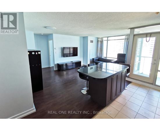 A kitchen with a black counter top and cabinets.