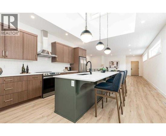 A modern kitchen with wooden cabinets and a green island.