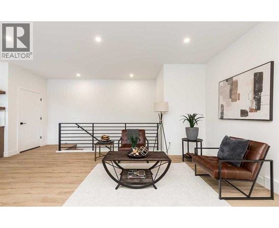 A living room with a brown leather chair and a white rug.