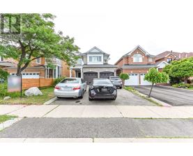 Two cars are parked in front of a house.