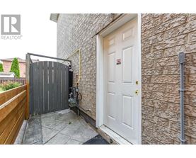 A white door is on the right side of a brick wall.