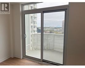 A room with a sliding glass door leading to a balcony.