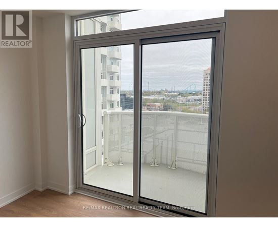 A room with a sliding glass door leading to a balcony.