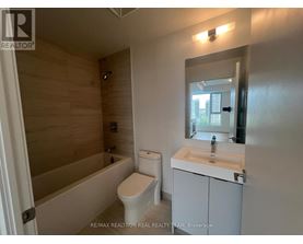 A bathroom with a toilet, sink, and bathtub.