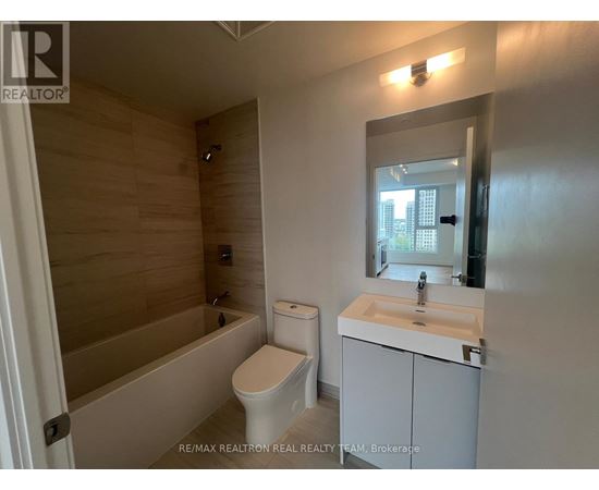 A bathroom with a toilet, sink, and bathtub.