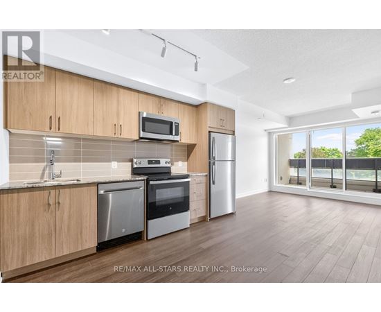 A kitchen with wooden cabinets and stainless steel appliances.