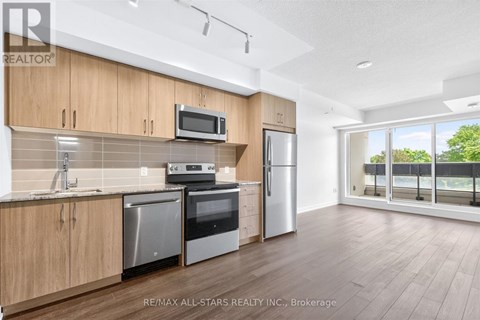 A kitchen with wooden cabinets and stainless steel appliances.