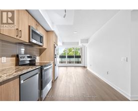 A kitchen with wooden cabinets and stainless steel appliances.
