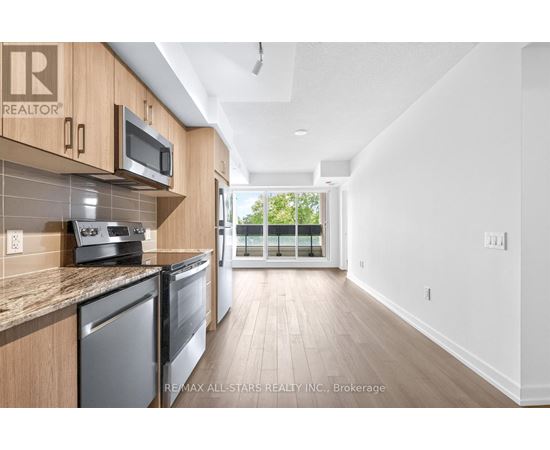 A kitchen with wooden cabinets and stainless steel appliances.