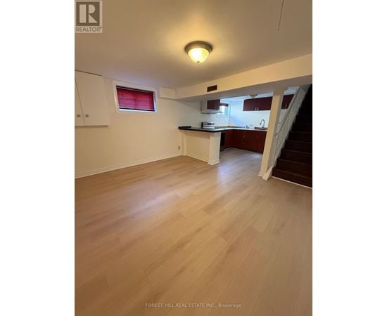 A real estate listing image of a kitchen and living room.
