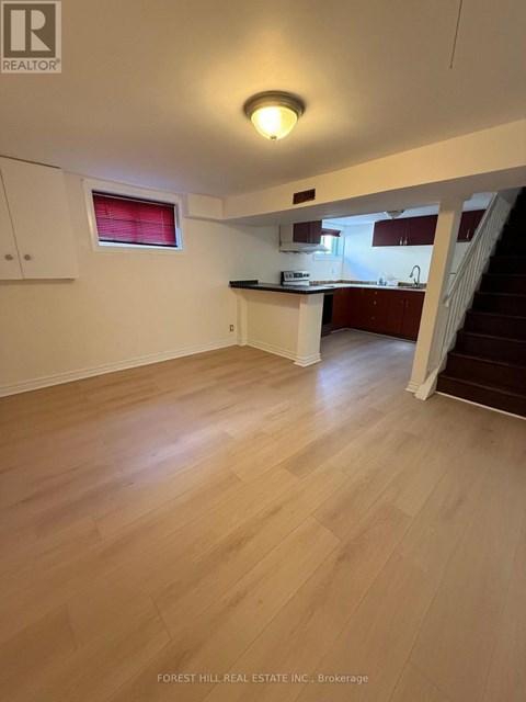 A real estate listing image of a kitchen and living room.
