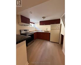 A kitchen with wooden floors and white appliances.