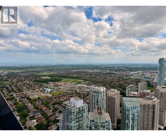 A cityscape with a mix of residential and commercial buildings under a cloudy sky.