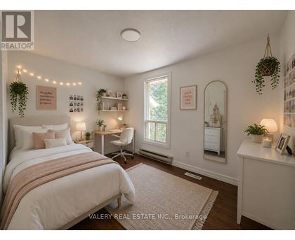 A bedroom with a bed, desk, and chair.
