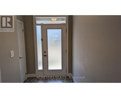 A door with a glass panel and a handle is in the center of the image.