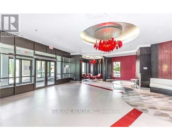 A large, open space with a red chandelier and a red carpet.