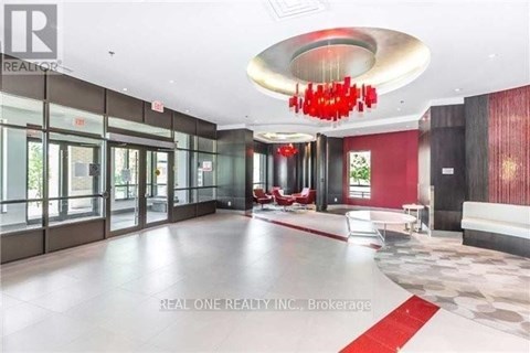 A large, open space with a red chandelier and a red carpet.