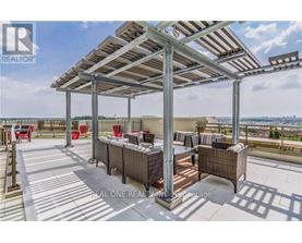 A patio with a metal roof and wicker furniture is shown.