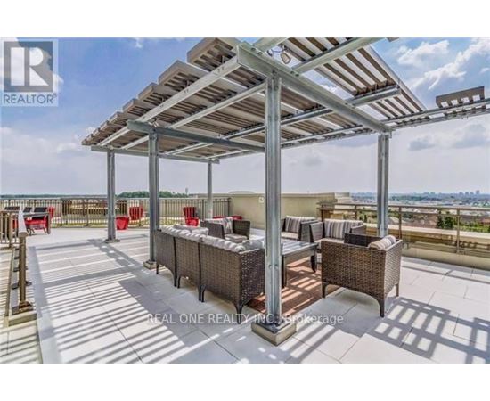 A patio with a metal roof and wicker furniture is shown.