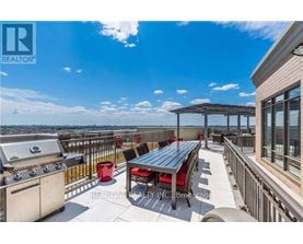 A balcony with a grill and a table.
