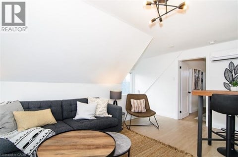 A living room with a grey couch and a wooden coffee table.