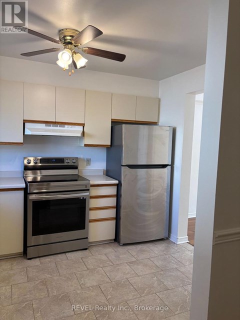 A kitchen with a stainless steel refrigerator and oven.