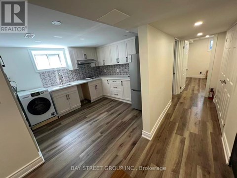 A kitchen with a washer and dryer built in.