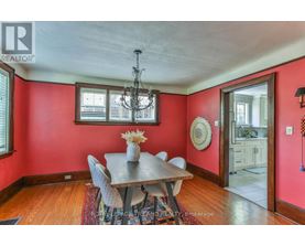 A dining room with a wooden table and chairs.