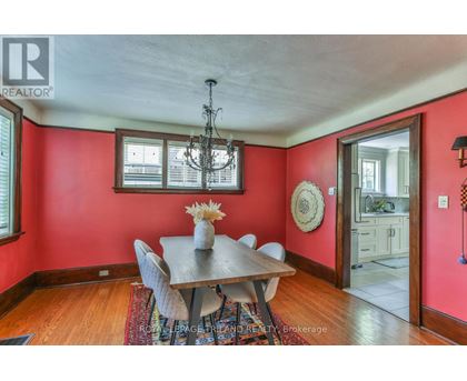 A dining room with a wooden table and chairs.