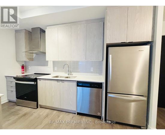 A kitchen with white cabinets and stainless steel appliances.