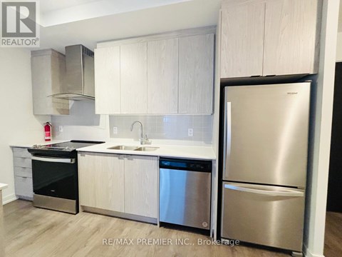 A kitchen with white cabinets and stainless steel appliances.