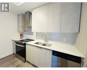 A kitchen with white cabinets and a stainless steel dishwasher.