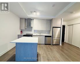 A kitchen with a blue island in the middle.