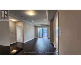 A spacious room with a view of the city through the windows.