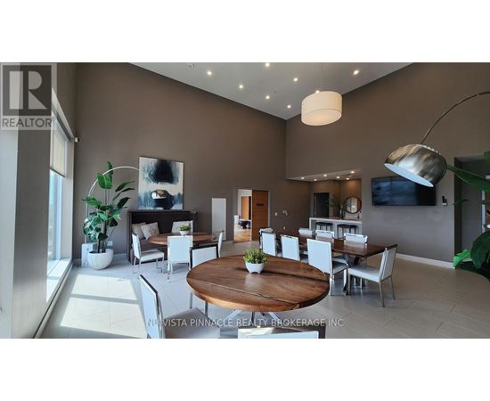 A modern living room with a wooden table and white chairs.