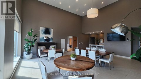 A modern living room with a wooden table and white chairs.